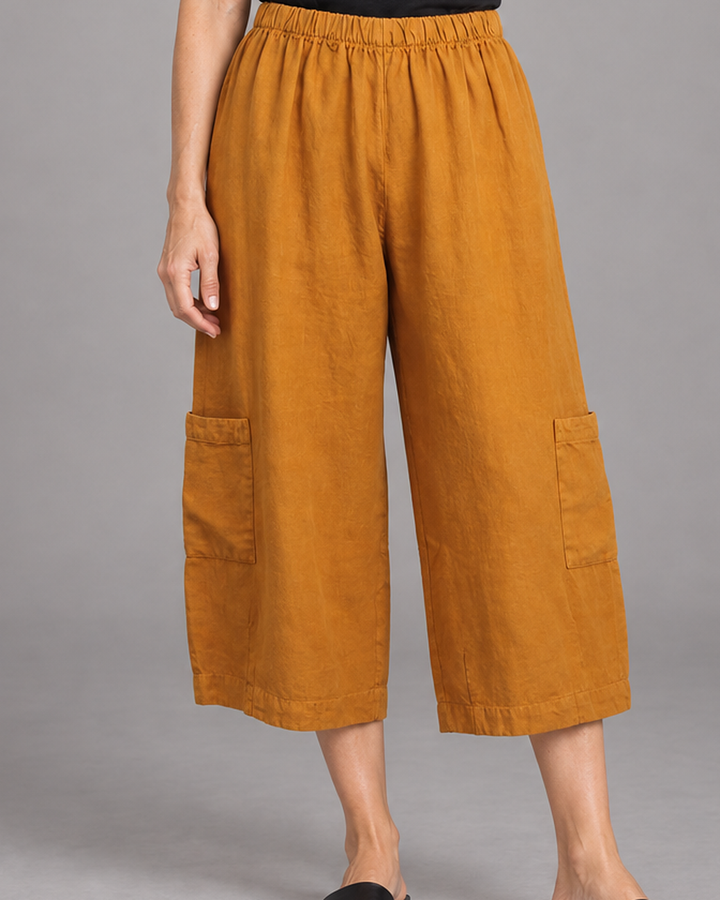 Bryn Walker Casbah Pant in Persimmon, heavy linen, detail view on model