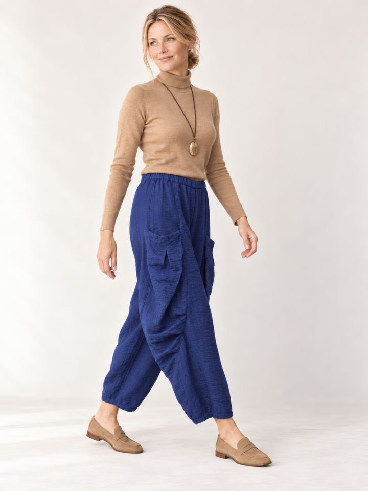 Eleven Stitch Design By Gerties Double Pocket Pant in Midnight, side view on model