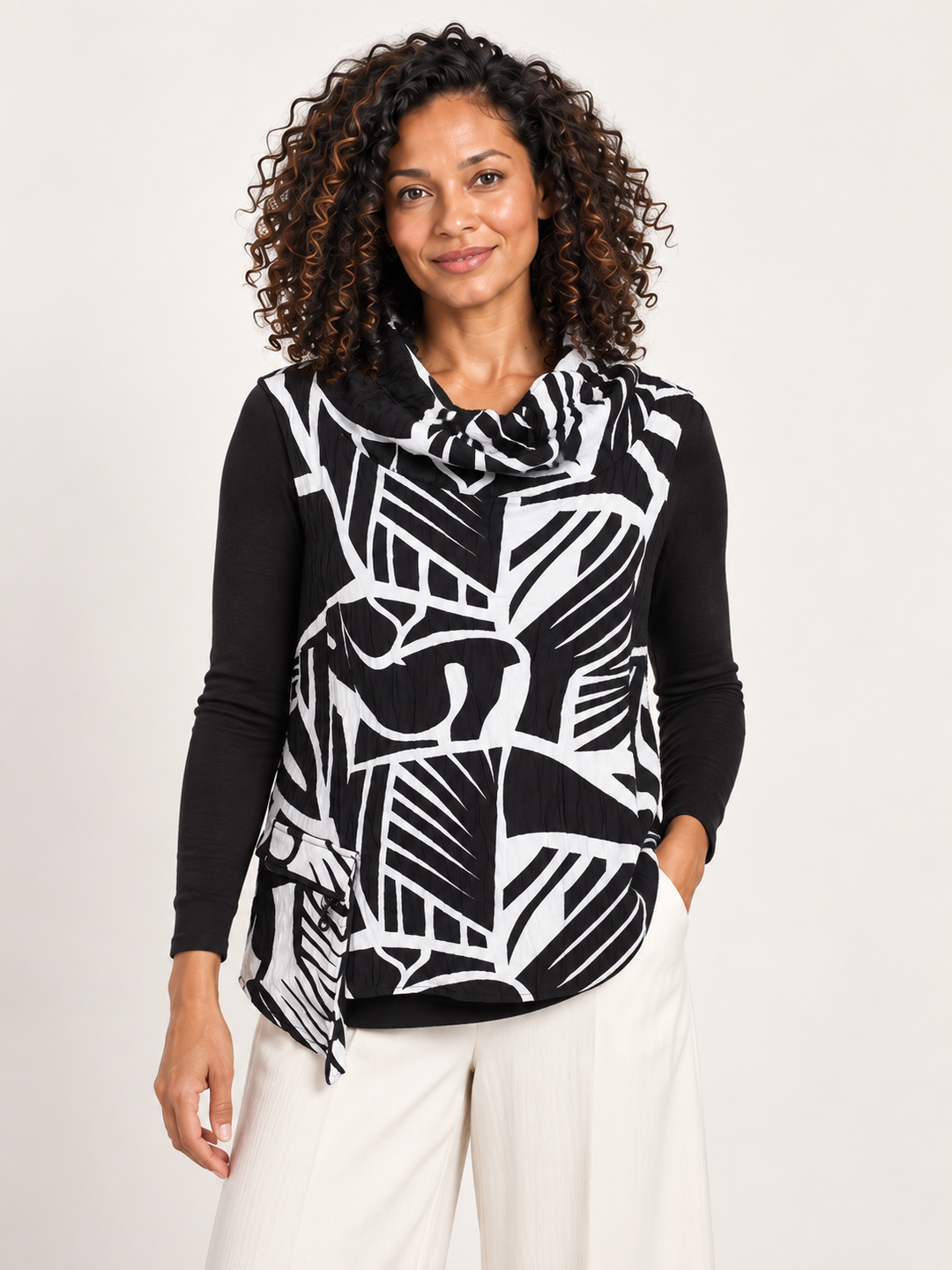 Kozan Aris Vest in Yang, sleeveless cowl neck pullover in black and white geometric print, front view on model