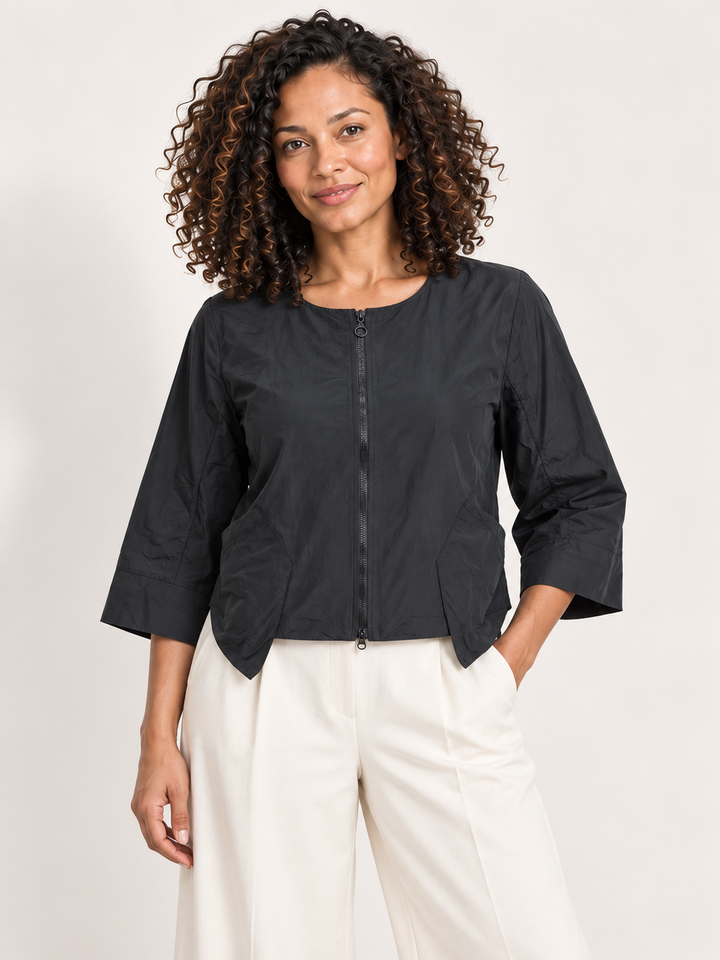 Kozan Arturo Jacket in Jet, cropped zip jacket with collarless neck and patch pockets, front view on model