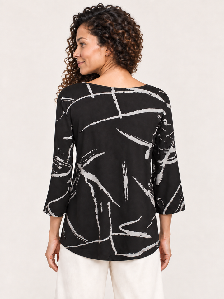 Back view, Kozan Juliana Top in Strike, gray brushstroke print on black jersey