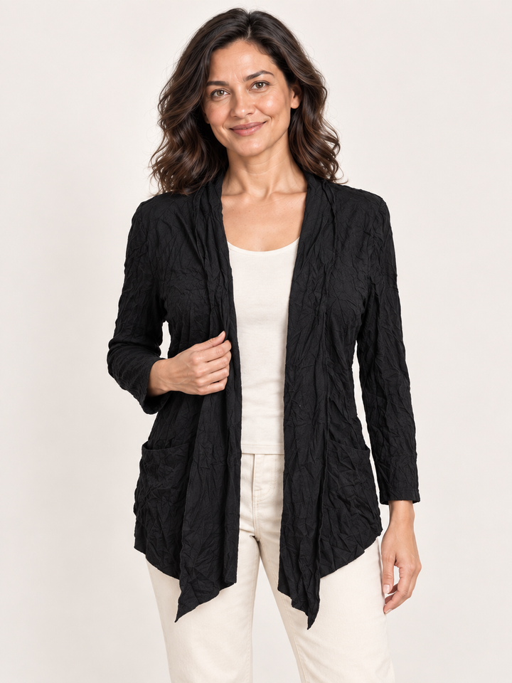 Kozan Melanie Jacket in Black Crinkle, drape front cardigan with two patch pockets, front view on model