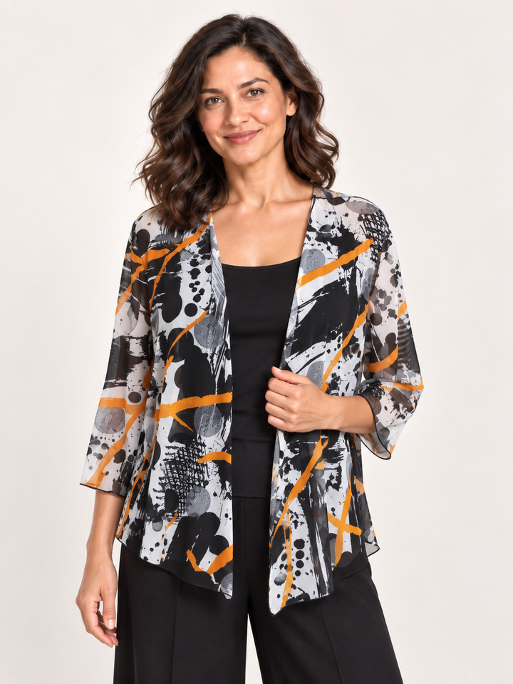 Kozan Melanie Jacket in Negroni, drape front cover up in black and white abstract print with orange streaks, front view on model