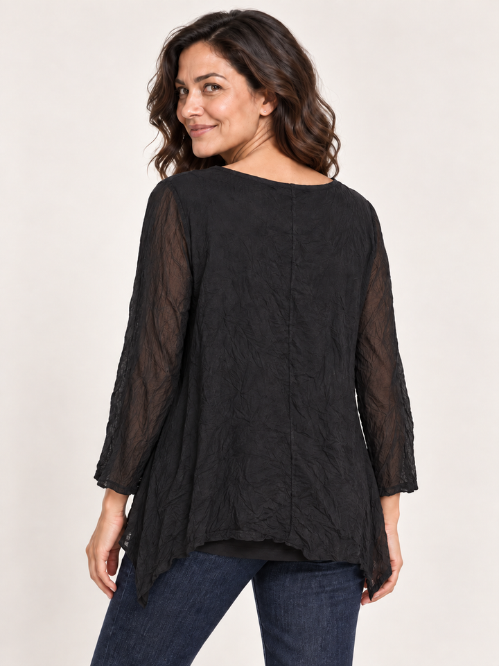 Back view, Kozan Mila Topper in Black Crush, crinkled solid black with sheer mesh sleeves